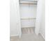 A functional closet with an open white door and shelving installed to help keep your wardrobe organized at 2708 N Buck Creek Rd, Greenfield, IN 46140