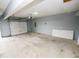A spacious garage with painted walls and an automatic door, offering parking and storage at 2708 N Buck Creek Rd, Greenfield, IN 46140