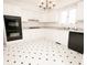 All-white kitchen featuring stainless steel appliances, plenty of counter space, and checkered flooring at 2708 N Buck Creek Rd, Greenfield, IN 46140