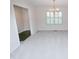 Bright living room with fresh neutral paint, carpet flooring, and a decorative chandelier at 2708 N Buck Creek Rd, Greenfield, IN 46140