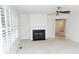 Bright and airy living room featuring a fireplace, window with white shutters, and french doors at 2708 N Buck Creek Rd, Greenfield, IN 46140