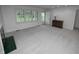 Bright living room with large window and new carpet flooring; neutral paint and trim throughout at 2708 N Buck Creek Rd, Greenfield, IN 46140