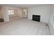 Open-concept living room with neutral carpet, fireplace, and a view into the dining room and kitchen at 2708 N Buck Creek Rd, Greenfield, IN 46140