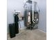 A utility room featuring a water heater, HVAC system, and water softener for home support at 2708 N Buck Creek Rd, Greenfield, IN 46140