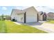 Backyard with a full lawn, partially covered patio, and a two car garage at 2761 Winding Creek Ln, Greenfield, IN 46140
