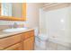 Bathroom with a white shower stall, a wooden vanity with white sink and faucet, and a toilet at 2761 Winding Creek Ln, Greenfield, IN 46140