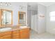 Bright bathroom featuring a double sink vanity, mirrors, and a shower with curtain at 2761 Winding Creek Ln, Greenfield, IN 46140