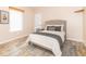 Bedroom with wood-look floors, a bed with pillows, an area rug, and a window with blinds at 2761 Winding Creek Ln, Greenfield, IN 46140