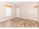 A cozy bedroom with wood-look flooring, a window with blinds, and a closet door at 2761 Winding Creek Ln, Greenfield, IN 46140