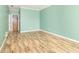 A bright bedroom with wood-look flooring and a bathroom accessible through the doorway at 2761 Winding Creek Ln, Greenfield, IN 46140