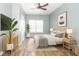 Staged bedroom with wood floors, neutral walls, and a bright window with a ceiling fan at 2761 Winding Creek Ln, Greenfield, IN 46140