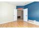 Bright bedroom with double doors, hardwood floors, and contemporary accent walls at 2761 Winding Creek Ln, Greenfield, IN 46140