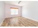 An airy bedroom with wood-look flooring, a window with blinds, and neutral walls at 2761 Winding Creek Ln, Greenfield, IN 46140