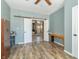 Bedroom with sliding doors to another room and wood-look floors at 2761 Winding Creek Ln, Greenfield, IN 46140