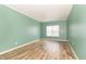 Empty bedroom featuring laminate flooring, white trim, and a window at 2761 Winding Creek Ln, Greenfield, IN 46140