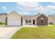 Lovely home boasts vinyl siding, brick features, an attached garage, and a green lawn at 2761 Winding Creek Ln, Greenfield, IN 46140