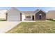 Charming single-story home with a brick and vinyl exterior and attached garage at 2761 Winding Creek Ln, Greenfield, IN 46140