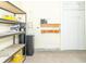 Garage features shelving for storage, water heater, and a small workbench at 2761 Winding Creek Ln, Greenfield, IN 46140