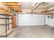 Spacious garage with an open ceiling, large door, and ample storage shelving at 2761 Winding Creek Ln, Greenfield, IN 46140