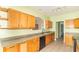 Well-lit kitchen with wooden cabinets, tile flooring, and a black dishwasher at 2761 Winding Creek Ln, Greenfield, IN 46140