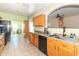 The kitchen showcases an open layout with wood cabinets and views of the sunroom, perfect for entertaining at 2761 Winding Creek Ln, Greenfield, IN 46140