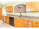 Kitchen featuring wood cabinets, black appliances, and an arched window at 2761 Winding Creek Ln, Greenfield, IN 46140