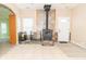 Living room boasting a charming fireplace with stone accents, light tile floor, and natural light at 2761 Winding Creek Ln, Greenfield, IN 46140