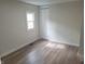 Clean bedroom with new flooring, white trim, and a closet at 2855 Walker Ave, Indianapolis, IN 46203