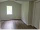 Bright bedroom with new flooring, window, and closet at 2855 Walker Ave, Indianapolis, IN 46203