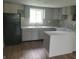 Updated kitchen with gray cabinets, new countertops, and mosaic backsplash at 2855 Walker Ave, Indianapolis, IN 46203
