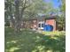 Exterior shot of the brick back of the home with sliding glass door, and blue trash bins visible at 2928 Cicero Rd, Noblesville, IN 46060