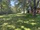Large backyard with trees; exterior shot of brick back of home is partially visible on the right of the frame at 2928 Cicero Rd, Noblesville, IN 46060