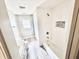 Bright bathroom featuring modern fixtures, a tub with tile surround, and a tiled floor at 2940 N Park Ave, Indianapolis, IN 46205