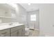 Bright bathroom with a vanity, a large mirror, and a shower with white subway tile at 2940 N Park Ave, Indianapolis, IN 46205