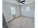 Spacious bedroom featuring carpeting, a ceiling fan, and a window at 2940 N Park Ave, Indianapolis, IN 46205