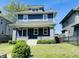 Charming two-story home featuring a covered porch, a well-manicured lawn, and classic architectural details at 2940 N Park Ave, Indianapolis, IN 46205