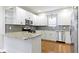 Modern kitchen featuring white cabinets, granite countertops, stainless steel appliances, and hardwood floors at 2940 N Park Ave, Indianapolis, IN 46205