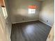 Cozy bedroom with wood-look flooring and ample natural light from a bright window at 3031 E 38Th St, Indianapolis, IN 46218