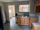 Functional kitchen featuring wood cabinetry and convenient pass-through to living area at 3031 E 38Th St, Indianapolis, IN 46218