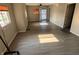 Open concept living room with natural light, neutral walls, and wood-style flooring at 3031 E 38Th St, Indianapolis, IN 46218
