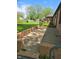 This backyard offers a quaint brick patio and lush greenery for enjoyable outdoor living at 3128 W 12Th St, Anderson, IN 46011