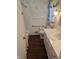 Bathroom shows white tile and a vanity, with floral wallpaper and a shower curtain at 3128 W 12Th St, Anderson, IN 46011