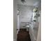 Bathroom offers a white vanity and tile, with floral wallpaper and shower curtain at 3128 W 12Th St, Anderson, IN 46011