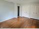 Bedroom featuring wood floors, closet, and a doorway to another room at 3128 W 12Th St, Anderson, IN 46011