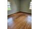 Bedroom featuring hardwood floors and natural light from two windows with backyard view at 3128 W 12Th St, Anderson, IN 46011