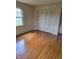 Bedroom with hardwood floors, large closet and window with backyard view at 3128 W 12Th St, Anderson, IN 46011