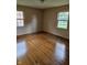 This bedroom features hardwood floors and natural light from two windows at 3128 W 12Th St, Anderson, IN 46011