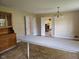 Inviting dining area with a vintage hutch, a spacious table with tile, and a view of the living room fireplace at 3128 W 12Th St, Anderson, IN 46011