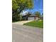 View of home with attached two-car garage, driveway, and well-maintained front lawn at 3128 W 12Th St, Anderson, IN 46011