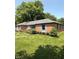 Exterior view of a well-kept brick home with manicured lawn and mature landscaping at 3128 W 12Th St, Anderson, IN 46011
